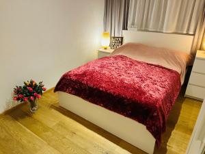 a bedroom with a bed with a red blanket at LUXURY STAY SALZBURG City in Salzburg