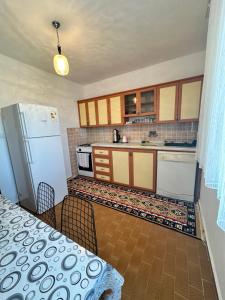 a kitchen with a table and a refrigerator at Albedo Apartment in Kaş
