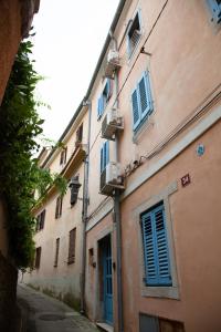 un grupo de edificios con persianas azules en una calle en Rosa di Pirano en Piran