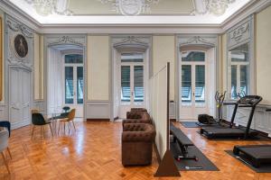 a living room with a couch and a gym at Via Emilio Bensa - Le Case di Bart in Genoa