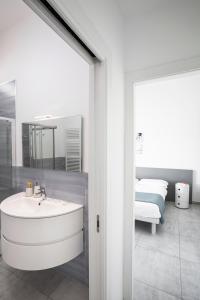 a bathroom with a white sink and a bedroom at Suite vista mare in Gaeta