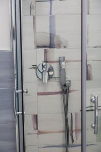 a shower with a hose attached to a wall at Suite vista mare in Gaeta