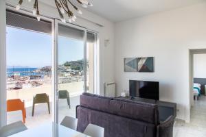 a living room with a couch and a view of the ocean at Suite vista mare in Gaeta