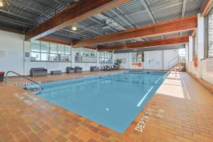 a large swimming pool in a large building at Ramada by Wyndham Jordan/Beacon Harbourside Resort in Jordan