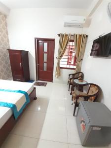 a bedroom with a bed and a table and chairs at HOTEL VIỆT ÚC, H17 Phan Huy Chú, phường Vũng Tàu in Vung Tau