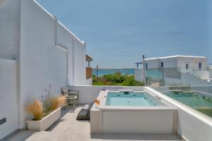 a balcony with a hot tub on top of a building at Marinatou Suites in Antiparos Town