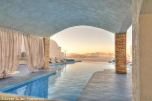 a hotel swimming pool with a view of the desert at Astarte Suites in Akrotiri