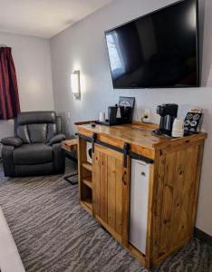 a hotel room with a television and a couch at First Gold Gaming Resort in Deadwood