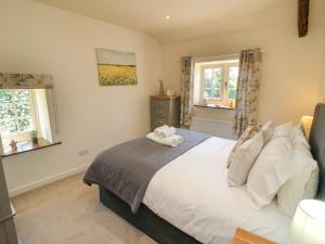 Ένα ή περισσότερα κρεβάτια σε δωμάτιο στο Tillers Cottage