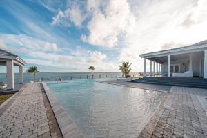a swimming pool with the ocean in the background at Largest Private Island Home & Pool Villa in Alice Town