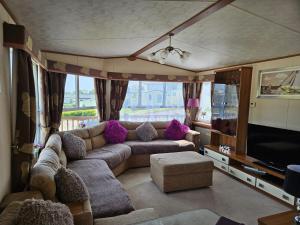 a living room with a couch and a television at 10 min walk to South Devon beach in Paignton