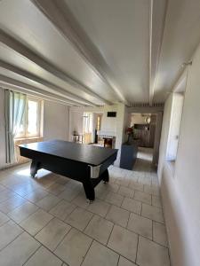 a ping pong table in the middle of a room at Camping De La Seine in Jumièges
