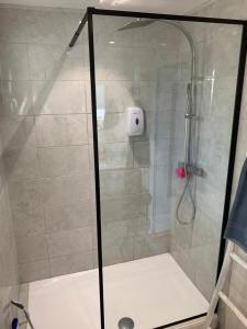 a shower with a glass door in a bathroom at La maison d’Eloi in Montignac-Charente +16 photos