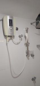 a bathroom with a sink and a hair dryer on a wall at BonVoyaageVilla in Trincomalee