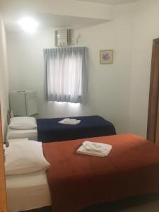a room with two beds and a window at Clip d´Oro Hotel in Camaçari