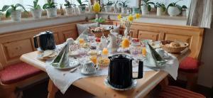 a table with food and drinks on top of it at Haus Stoaröserl in Schönau am Königssee