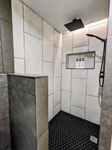 a bathroom with a shower with white tiles at Canyon Coze - Ski, Board, Sled, Bike, Hike in Ogden