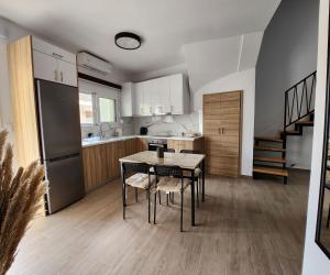 a kitchen with a table and chairs in a room at Loft Apartment in Kos in Kefalos