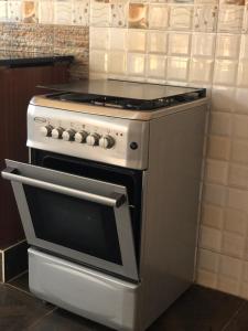 a kitchen with a white stove with a stove top oven at Marina Lake View Apartments,Jinja in Jinja