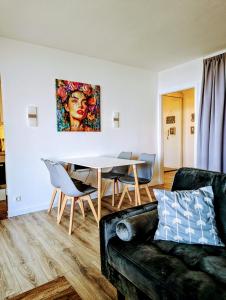 a living room with a couch and a table at Panorama-Meerblick am Scharbeutzer Strand in Scharbeutz