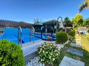 a swimming pool with a swing in a yard at Villa Annabèll in Belek