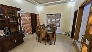 a dining room with a table and chairs at Tea Mitra Holiday Homes in Vagamon