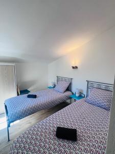 a room with two beds and two tables at La villa De Lina 637 -Self Check In - in Gallargues-Le-Montueux +10 photos