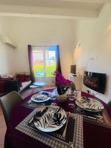 a living room with a table with plates on it at La villa De Lina 637 -Self Check In - in Gallargues-Le-Montueux