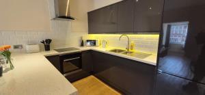 a kitchen with a sink and a counter top at Modern 1 Bedroom apartment in Town centre in Ipswich