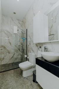 a bathroom with a toilet and a sink and a shower at Peaceful Suite Beachfront Getaway in Mağusa