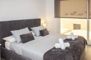 a bedroom with a large bed with two pillows at Gaviotas Golf Beach in Almerimar