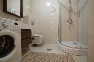 a bathroom with a shower and a washing machine at Soul of the Kotor Bay in Dobrota +14 photos