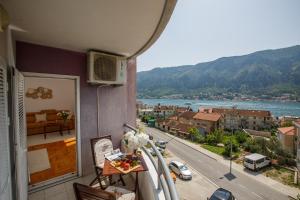 a balcony with a view of a city and a road at Soul of the Kotor Bay in Dobrota