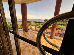 a mirror in front of a balcony with a view at Marina Lake View Apartments,Jinja in Jinja