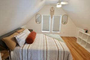 a bedroom with a bed and two mirrors on the wall at Boho Bliss - 1Br, 1Bath w/Patio! in Chicago