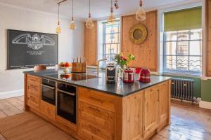 a kitchen with a large island in a room at Luxury Georgian Townhouse in heart of Norwich Sleeps 4 in Norwich +21 photos