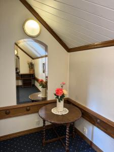 a room with a table and a mirror at Veszprémvölgyi Kúria in Veszprém