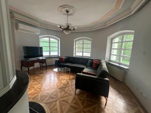 a living room with a couch and a piano at Elite House in Palić