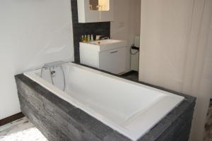 a white bath tub in a bathroom with a sink at B&B Villa Castelnau Montpellier in Castelnau-le-Lez