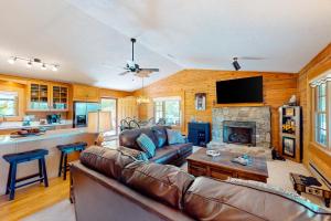 a living room with a couch and a fireplace at Blue Spruce Retreat in Waynesville