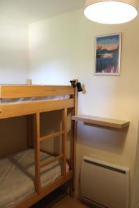 a room with a bunk bed and a fan at Studio cosy avec terrasse au cœur du village in Xonrupt-Longemer