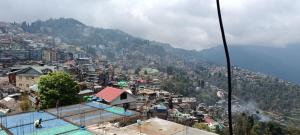 a view of a city from a mountain at HOTEL RATNA in Darjeeling