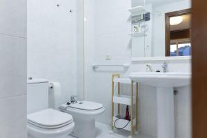 ein weißes Badezimmer mit Toilette und Waschbecken in der Unterkunft Bleumaison-a mariña portonovo in Portonovo