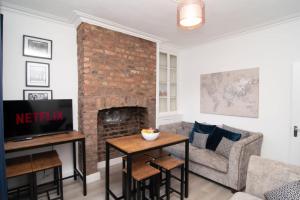ein Wohnzimmer mit einem Sofa und einem Kamin in der Unterkunft Central 4bed house, free parking in Liverpool