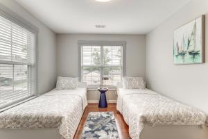 two beds in a room with two windows at Modern Virginia Beach Retreat in Resort District! in Virginia Beach