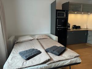 a bed with two towels on it in a room at Central Pearl Apartment in Reykjavík