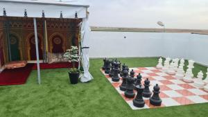 a chess board on the grass next to the water at Camping on the rooftop close to Casablanca Airport in Dah Hammou Ben Cheïkh