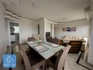 a dining room and living room with a table and chairs at Apartamento 2/4 completo e aconchegante em Salvador in Salvador