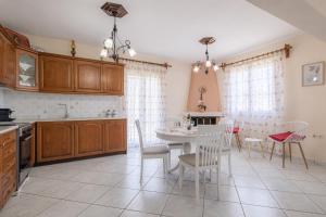 eine Küche und ein Esszimmer mit Tisch und Stühlen in der Unterkunft Regina's House in Skopelos + 74 Fotos