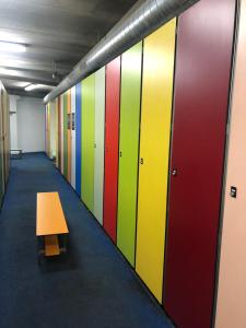 a hallway with colorful lockers and a wooden bench at Apartamento en Baqueira a 100 metros de la telecabina in Naut Aran